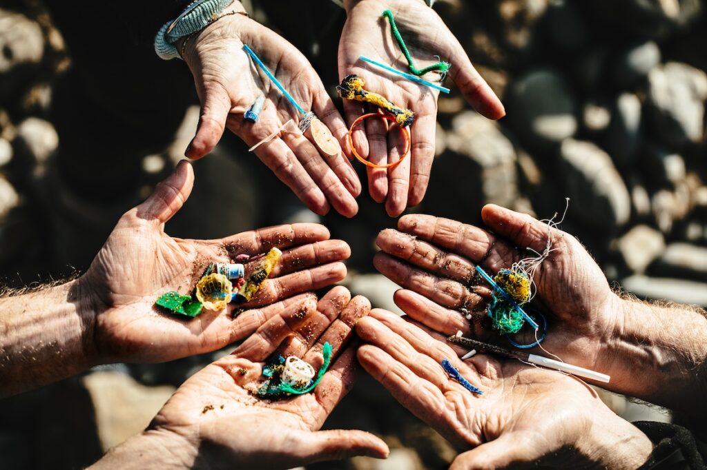 Hands full of plastic debris collected from beach at Bude north Cornwall