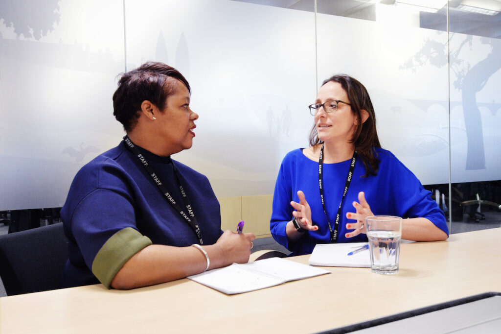 Two female members of staff in discussion