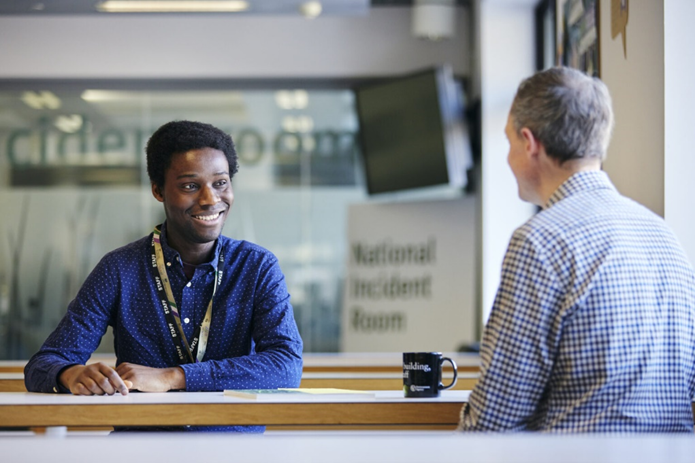 Two EA team members chatting about the day over a hot drink