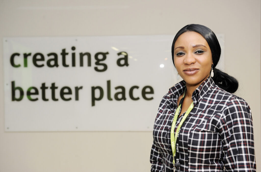 EA team member smiling for a photo in an EA office